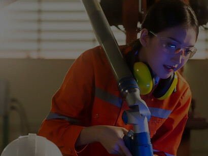 Streamline quality control and operational processes: Asian female engineer specialist and technician maintenance inspect relay robot arm system using a laptop for precise control
