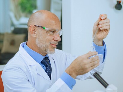A man in a lab coat looking at a sample. Nanotechnology has the potential to transform disease diagnosis 