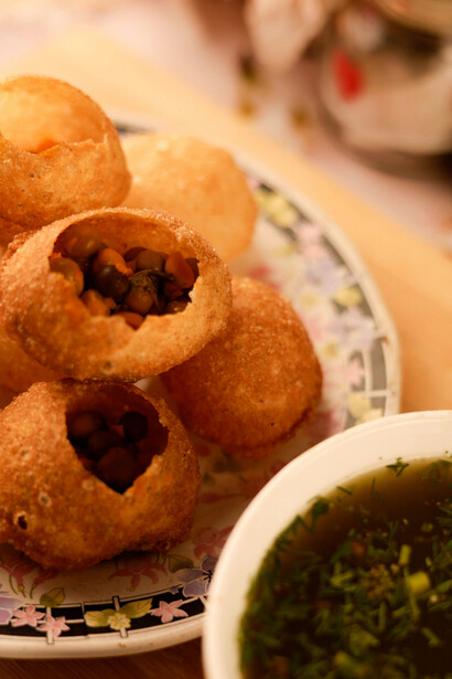 Pani Puri reimagined: the classic gol gappa presented elegantly on a ceramic plate in fine dining style