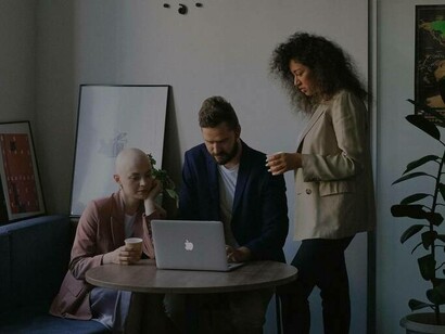 A group of colleagues working together on a project at work and forming a friendship