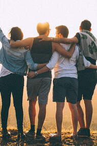 A tender embrace of friends under the sunset, reminding us that our strength often lies not in independence, but in the arms of those who never let us fall