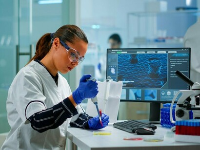 A researcher analyzes advanced data models in a state-of-the-art laboratory, symbolizing the cutting-edge innovation vital for regional economic development and national sovereignty