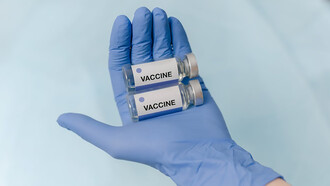 Doctor's hands holding vaccine