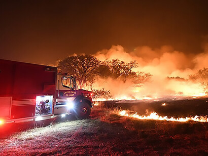 A U.S. Air Force fire truck responds to a large wildfire Apr. 9, 2022 at Joint Base San Antonio - Camp Bullis demolition range area, Texas, USA