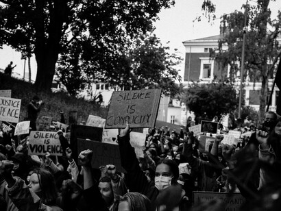A black-and-white image showing a crowd of protesters