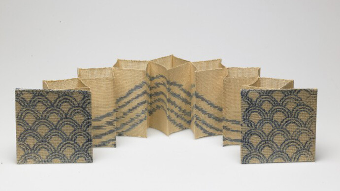 Kay Sekimachi, “Wave”, 1980. Woven book of linen, acrylic paint, and buckram (lining); double weave and warp-painting, 4 3/8 x 4 3/8 x 18 in. Gift of the artist, 2005.124