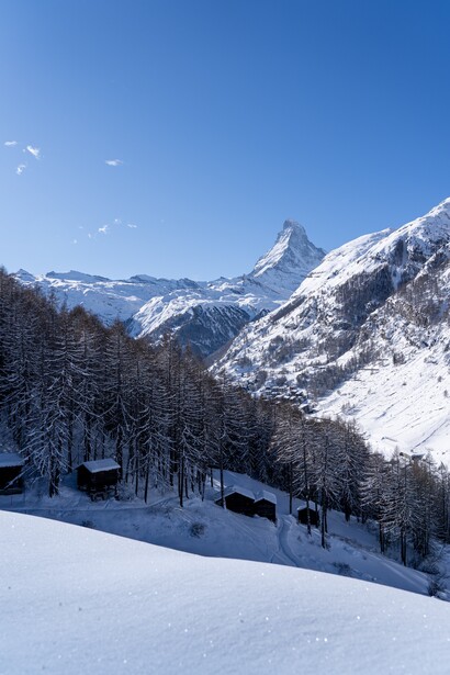 A mountain and some cabins. For climate change to improve, corporations and of societies will need to be convinced and be helped to abandon harmful practices