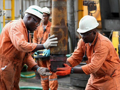 Men at work. The sole reliance on crude oil as a major export should stop and the economy needs diversification
