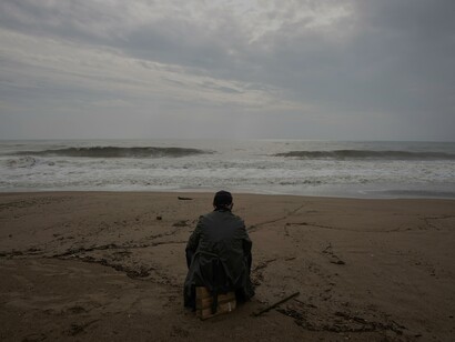 Homem solitário na beira do mar