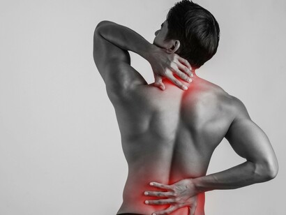 Straining from both neck and lower back pain, this image captures the double trouble many face each morning