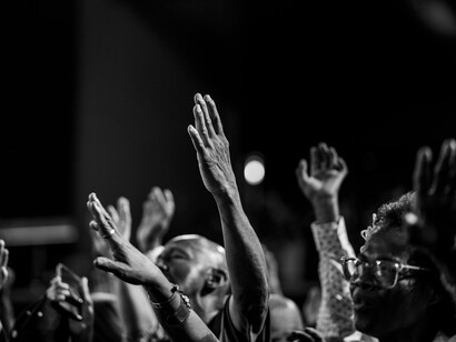 Raised hands echoing a shared moment of devotion