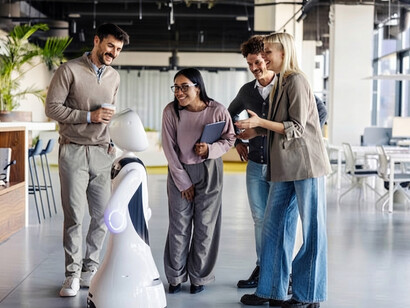 Colleagues interact with an intelligent humanoid robot in a contemporary workplace