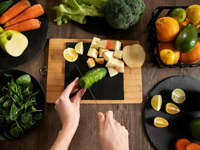 A woman carefully prepares her favorite juice recipe, blending fresh fruits and vegetables with precision and creativity to craft a nutritious and refreshing drink