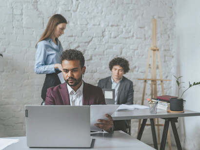 A man using a laptop in a call center, illustrating the role of ghost workers
