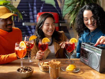 Friends toasting with brunch cocktails and prosecco, as they gather around a table filled with mouthwatering dishes for a leisurely brunch experience