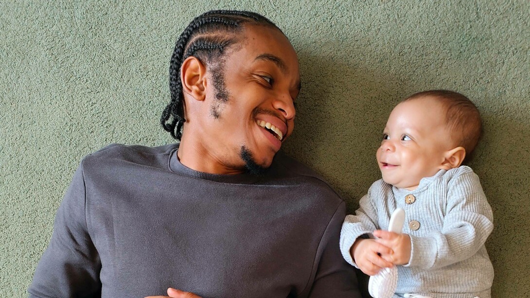 A man smiling with his baby
