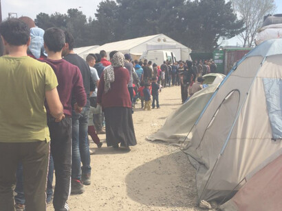 Families wait in long lines for food from aid organizations. Many have now run out of money to purchase their own food in Indomeni, Greece, March 31, 2016