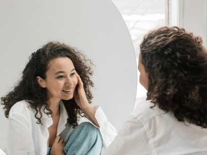 Woman offering affirmation in the mirror