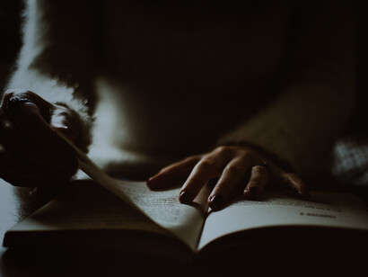 A young girl trying to study, sitting down