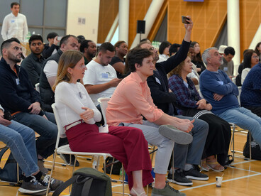 A diverse audience attending an indoor conference focused on civil society and community engagement