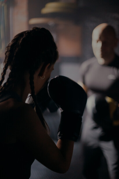 Trainee boxing with her coach, box