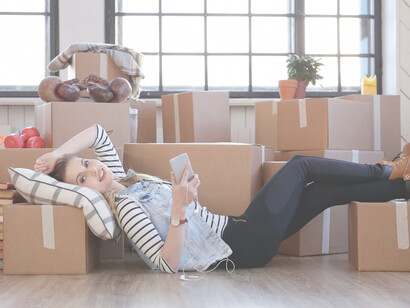 Having finished decluttering, the woman lies on the floor, feeling refreshed and revitalized