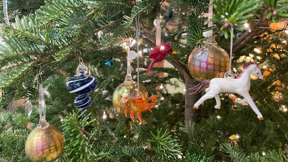 Ornaments hanging off a tree at the gallery in Hudson Beach Glass