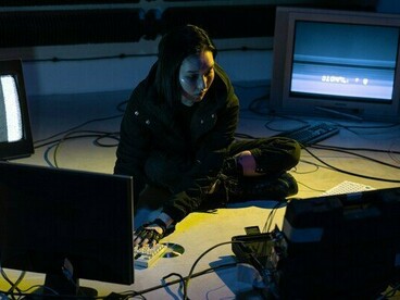 A digital analyst operating in a computing network, symbolising the constant battle between cyber attackers and defenders