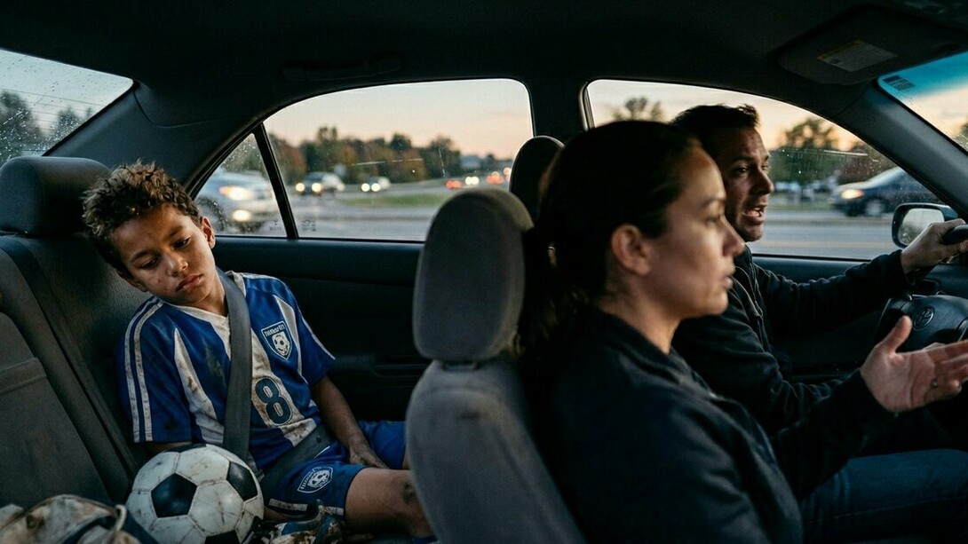 A child processing a painful loss in the back seat, representing the moments when parental support matters most