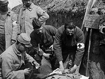 A regimental aid post in a World War I trench, where wounded soldiers received emergency medical treatment near the front lines. These makeshift medical stations played a vital role in caring for casualties amid the harsh conditions of trench warfare