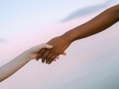 Two people hold hands
