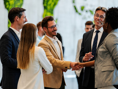Delegates networking at an international business conference, exchanging ideas and strengthening diplomatic and economic ties