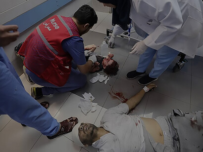 In the aftermath of an Israeli airstrike on October 11, 2023, wounded Palestinians await treatment in the overcrowded emergency ward of Al-Shifa Hospital in Gaza City