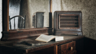 Polvoriento escritorio con un libro abandonado de una vieja habitación