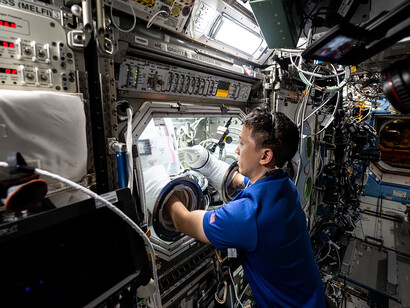 NASA astronaut and Expedition 73 Flight Engineer Jonny Kim conducts research inside the Destiny laboratory module’s Microgravity Science Glovebox aboard the International Space Station. He swaps syringes containing protein samples and installs test cells for the Ring-Sheared Drop Interfacial Bioprocessing of Pharmaceuticals experiment, which uses surface tension to contain liquids and study proteins without contact with solid walls. The results may advance pharmaceutical manufacturing and 3D printing technologies both in space and on Earth.