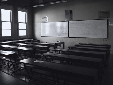 A quiet classroom without students, symbolising the fragile sense of safety within educational spaces