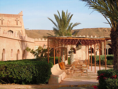 Bathed in the warm glow of the setting sun, the Ksar Tafnidilt in Tan-Tan, Morocco, offers a serene retreat for travelers seeking respite from the bustling city life