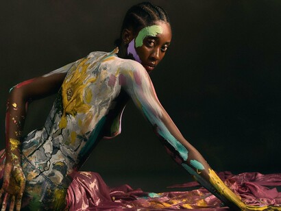A woman transformed into a canvas of vivid colours, reflecting the deeply personal nature of artistic expression