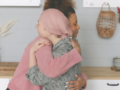 A woman with cancer and her close friend hugging