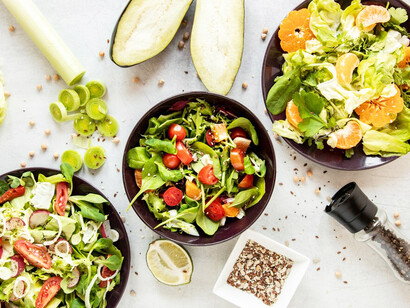 A vibrant salad with fresh fruits and vegetables, highlighting nutritious plant-based ingredients for a vegan diet