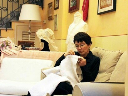 Woman sewing a dress of linen