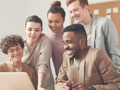 In a bustling workspace, professionals huddle around documents, underscoring the pivotal importance of seamless communication in driving collective comprehension and successful collaboration