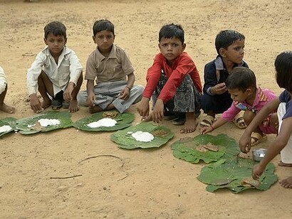 Children eating kheer and puri to combat malnutrition, Chambal, India