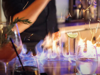 A bartender prepares a flaming drink at Le Grand Restaurant in Los Angeles, United States