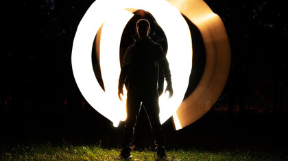 A person illuminated by bright lights, drawing attention