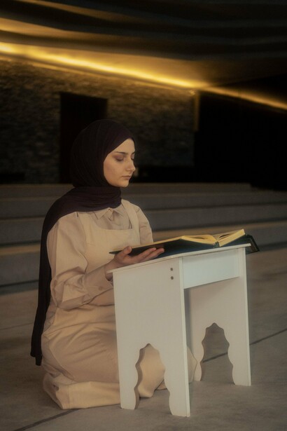 A woman dedicating herself to Quranic learning, symbolising the spirit of learning that has flourished for centuries