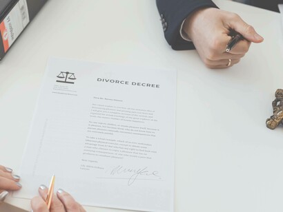 Woman reading divorce papers in lawyers office
