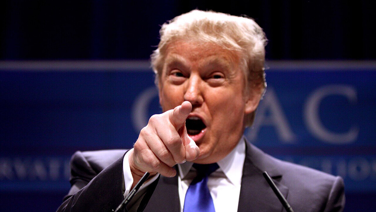 Former President Donald Trump pointing at a the crowd at a press conference