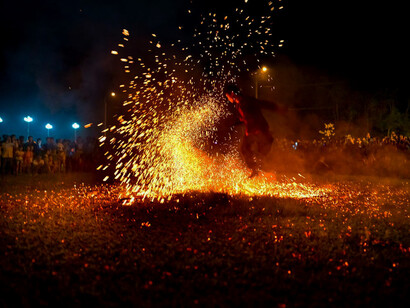 Dancing amidst flames, this performer embodies the journey towards planetary consciousness, where understanding universal laws offers salvation for humanity's future