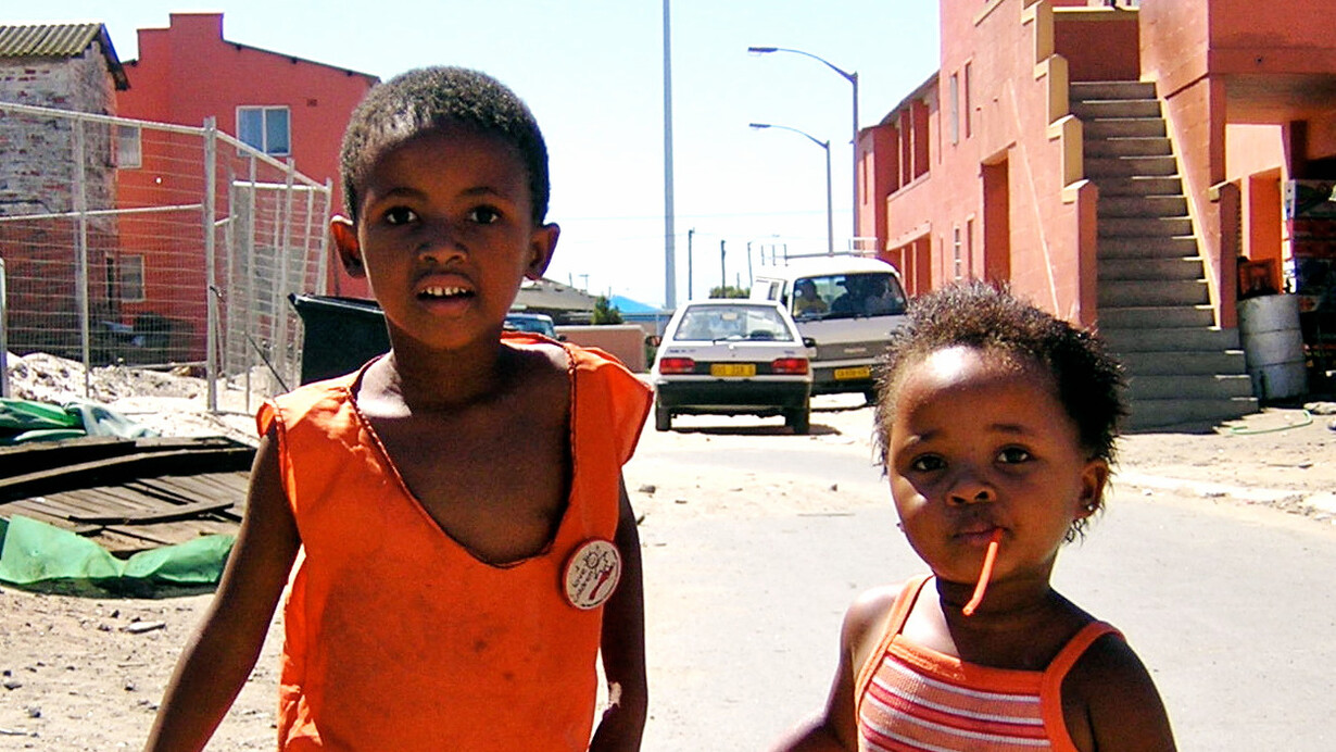 Amidst the vibrant life of Langa township in Cape Town, South Africa, two children embody the aspirations for equitable living conditions and social justice advocated in international human rights frameworks